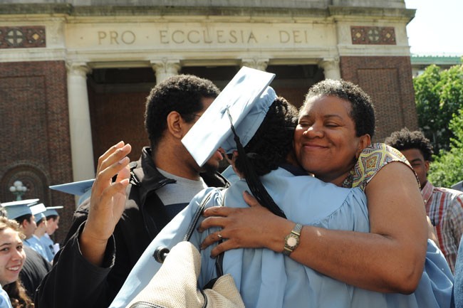 Mother hugging her daughter after the Baccalaureate ceremony outside the front of St. Paul's Chapel.