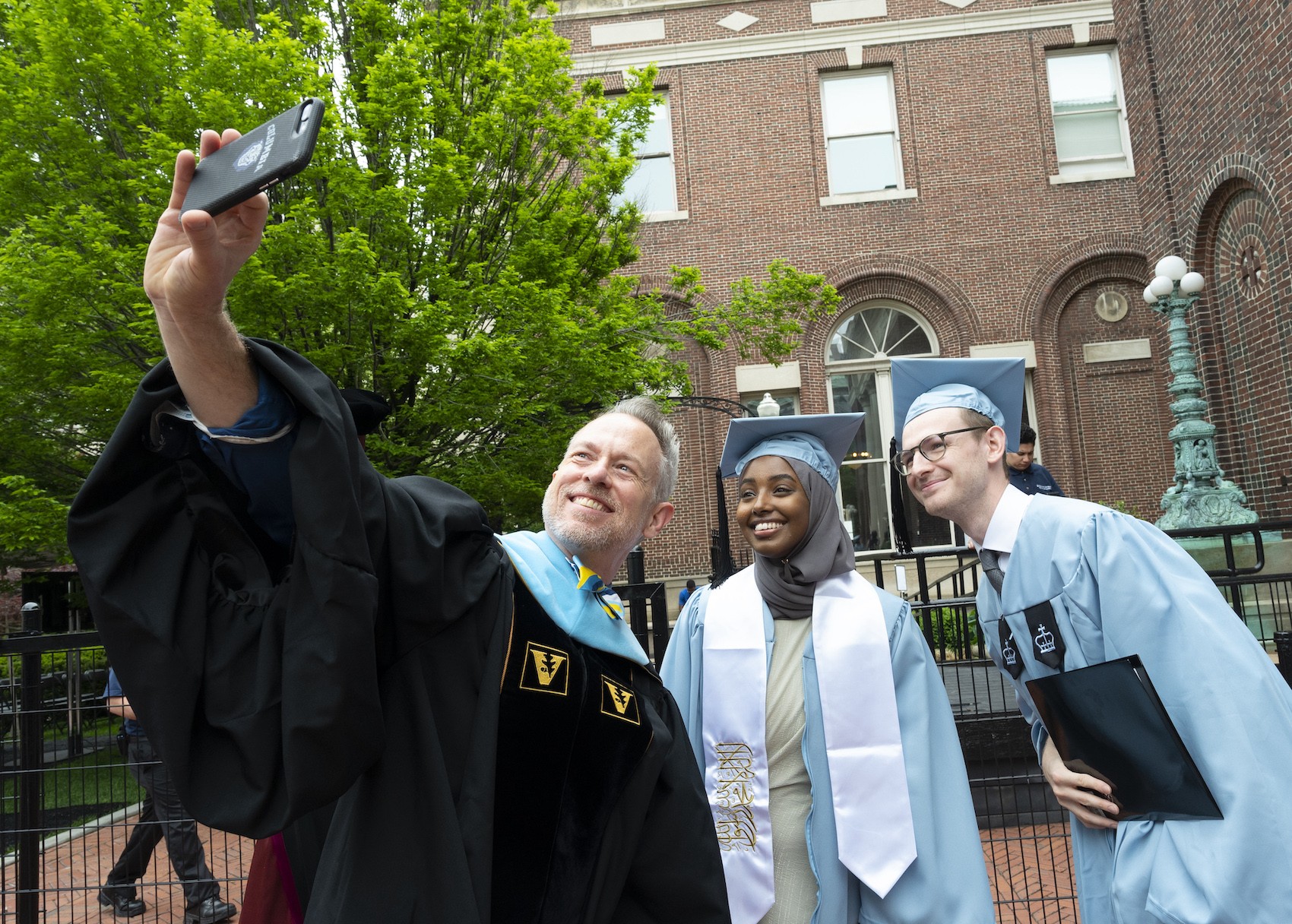 Vice President for Student Affairs Jospeh Greenwell and two Baccalaureate Speakers pause for a selfie. 