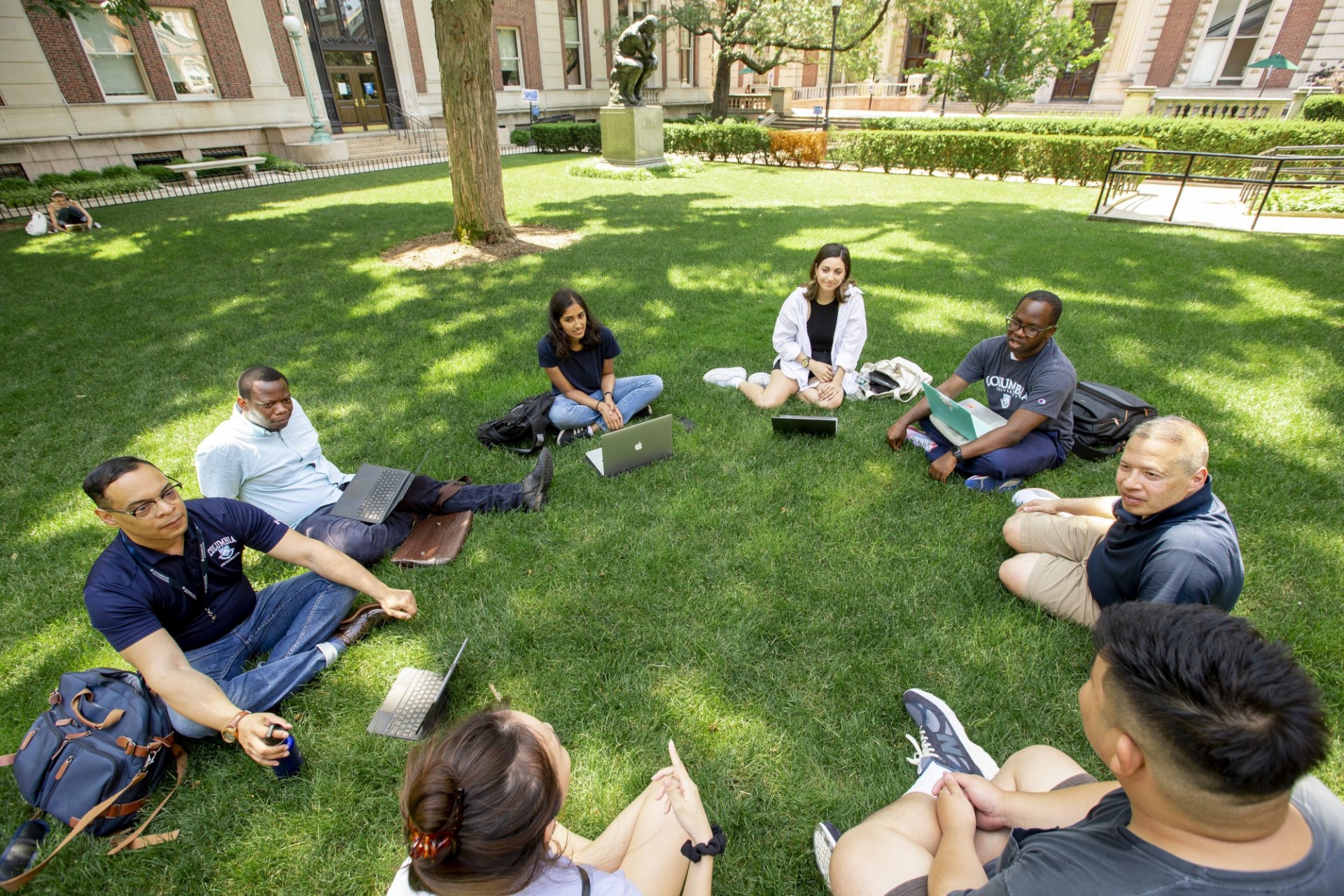 Students sitting in a circle talking.