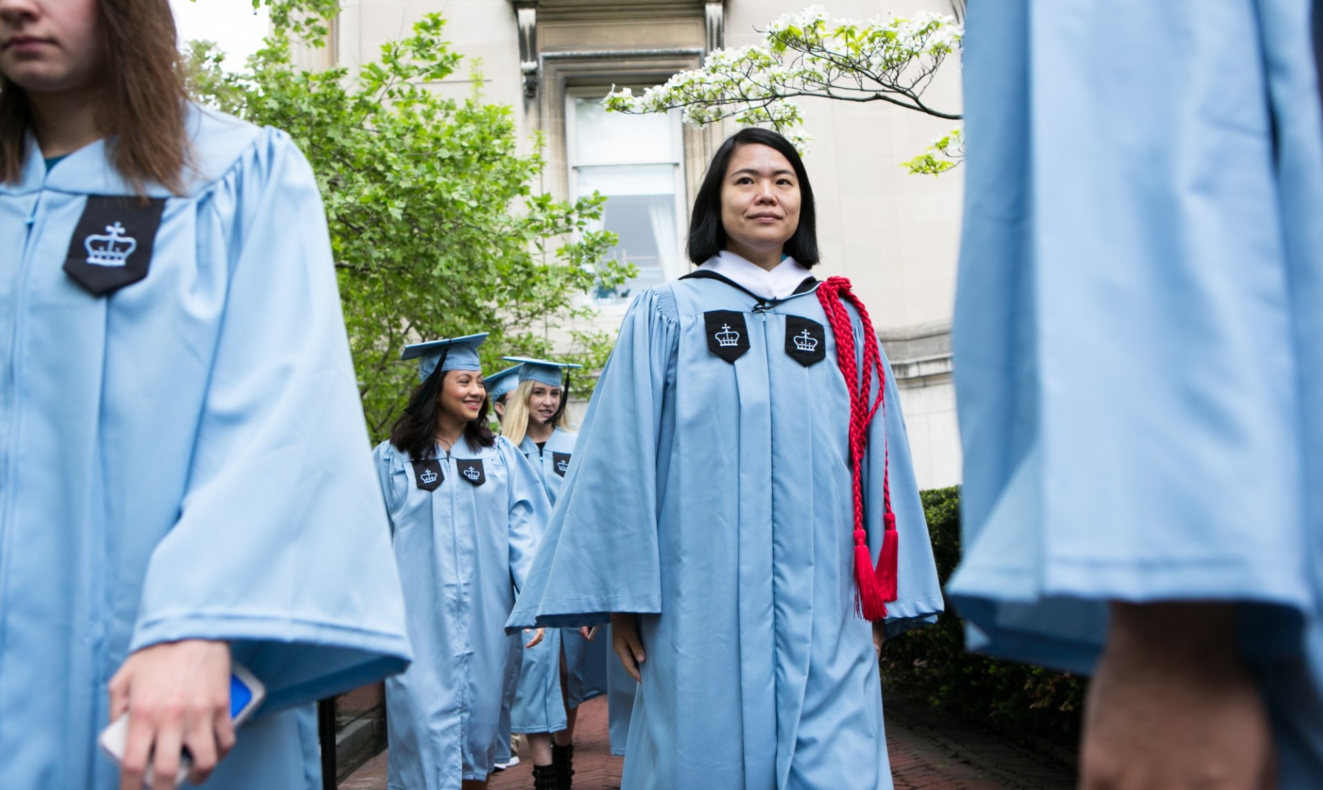 Students walking from Lowe Library to the Baccalaureate ceremony in traditional Columbia blue regalia. 