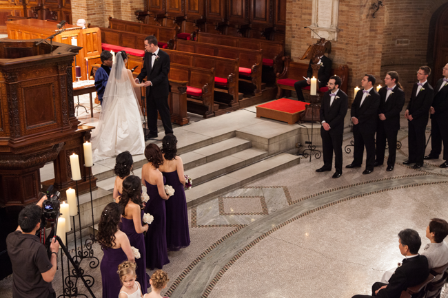Bride and groom being married by Chaplain Davis in the Sacred Space in St. Paul's chapel flanked by their wedding party.