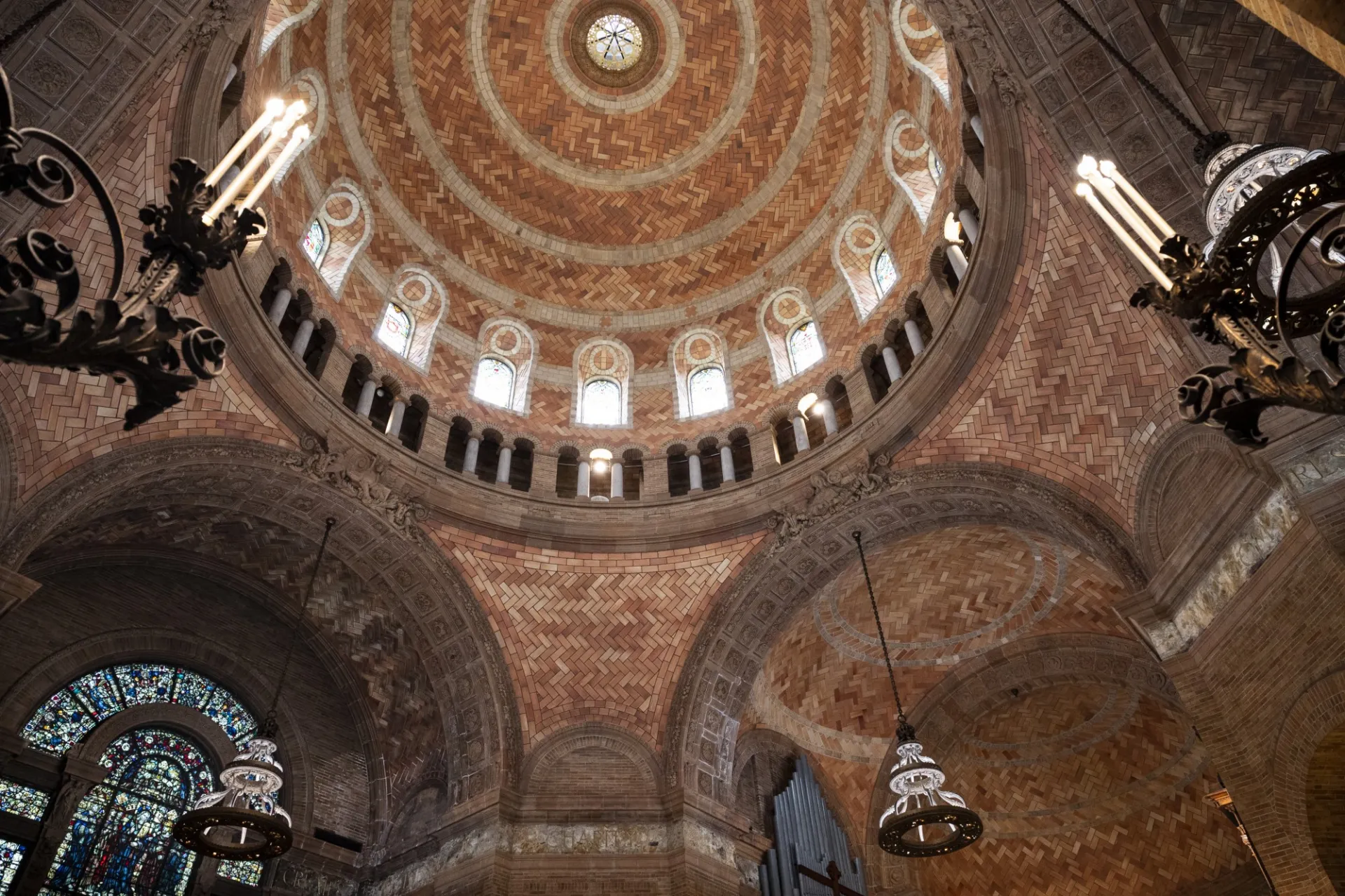 Chapel dome ceiling showcasing archways and chandeliers. 