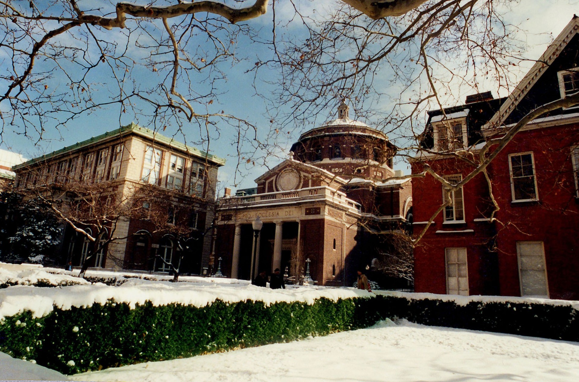 Exterior facade of St. Paul's Chapel on a sunny, snow covered day.